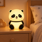 Cute panda LED night lamp glowing beside a cosy bedside table